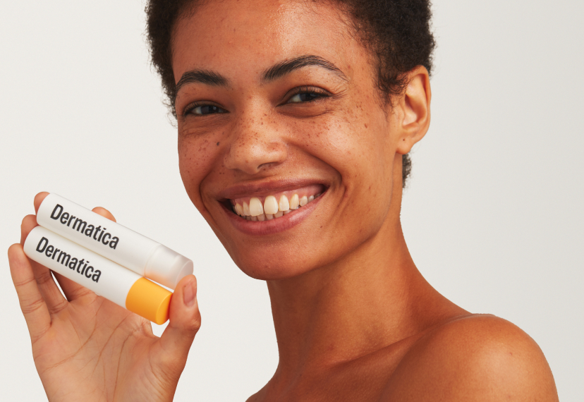 Smiling Woman With Dermatica Bottle